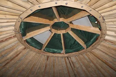a round wooden ceiling in a wooden hut at Yurtos in Gaugariai