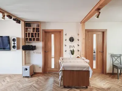 a room with a bed and a table in it at Old Town Jiva apartment in Kaunas