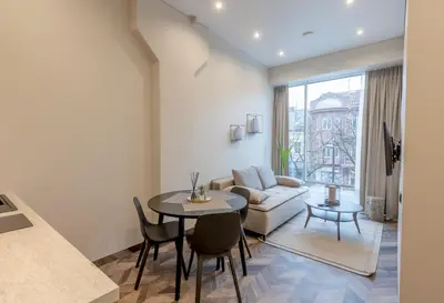 a living room with a table and a couch at LAISVĖ BOUTIQUE APARTMENTS in Kaunas