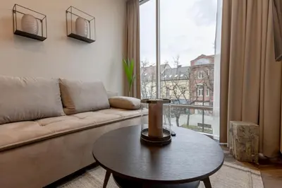 a living room with a couch and a table at LAISVĖ BOUTIQUE APARTMENTS in Kaunas
