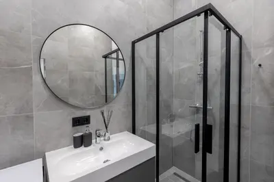 a bathroom with a sink and a mirror at LAISVĖ BOUTIQUE APARTMENTS in Kaunas
