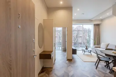 a living room with a table and a couch at LAISVĖ BOUTIQUE APARTMENTS in Kaunas