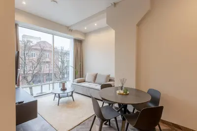 a living room with a table and a couch at LAISVĖ BOUTIQUE APARTMENTS in Kaunas