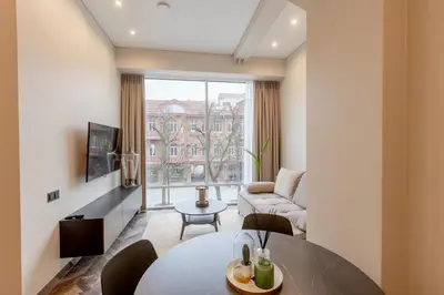a living room with a table and a couch at LAISVĖ BOUTIQUE APARTMENTS in Kaunas