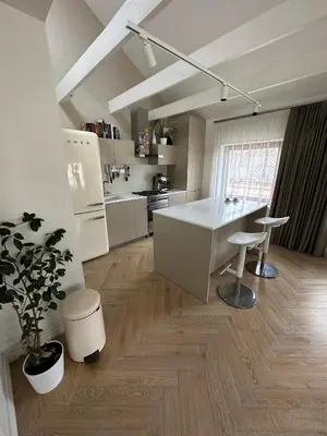 a kitchen with a white island in a room at The Most Central Apartment in Kaunas