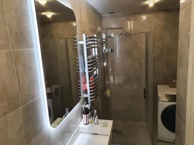 a bathroom with a shower and a sink with a mirror at The Most Central Apartment in Kaunas