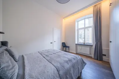 a bedroom with a bed and a window at Jasinskio Apartament - Lollo Stay in Vilnius