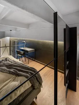 a bedroom with a bed and a desk at Stylish Black and White loft in Kaunas