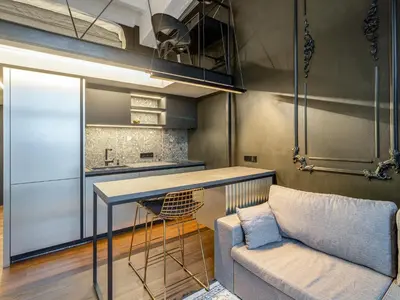 a kitchen with a couch and a table in a room at Stylish Black and White loft in Kaunas