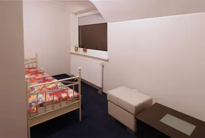 a small bedroom with a bed and a window at Luka in Marijampolė