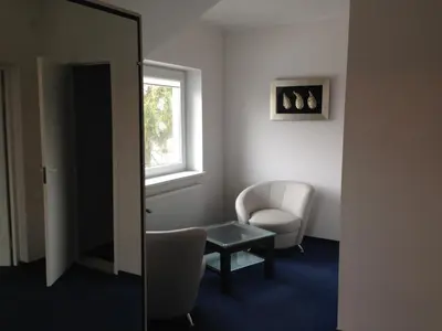 a room with a table and a chair and a window at Luka in Marijampolė
