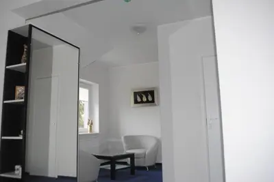 a living room with a mirror and a table at Luka in Marijampolė