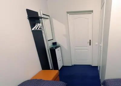 a room with a hallway with a blue carpet and a door at Luka in Marijampolė