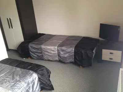 a hotel room with two beds and a flat screen tv at Luka in Marijampolė