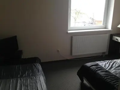 a room with two beds and a window at Luka in Marijampolė