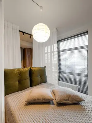 a bedroom with a large bed with a large window at Cosy Panoramic Studio in the center for 1-2 pers. in Kaunas