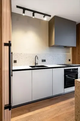a kitchen with white cabinets and a sink at Cosy Panoramic Studio in the center for 1-2 pers. in Kaunas