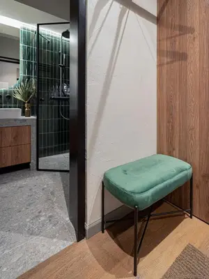 a stool with a green seat in a bathroom at Cosy Panoramic Studio in the center for 1-2 pers. in Kaunas