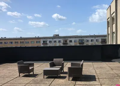 three chairs and a table on top of a building at Cosy Panoramic Studio in the center for 1-2 pers. in Kaunas
