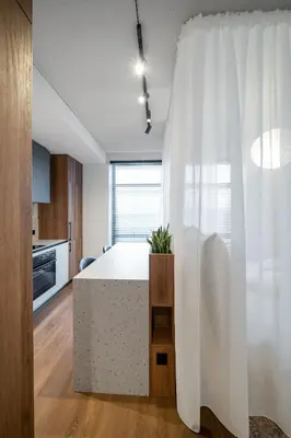a kitchen with a large white table in a room at Cosy Panoramic Studio in the center for 1-2 pers. in Kaunas