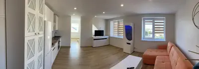 a living room with a couch and a television at Centro apartamentai in Kalvarija