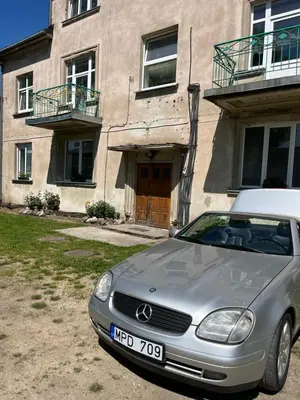 a silver car parked in front of a building at Centro apartamentai in Kalvarija