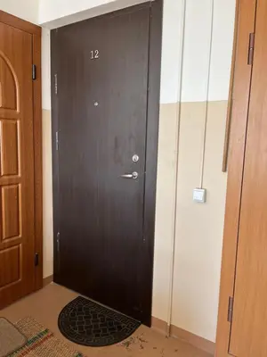 a black door with the number on it at Centro apartamentai in Kalvarija