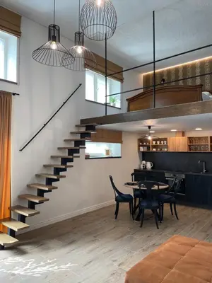 a staircase in a living room with a table and chairs at Kęstučio 55 in Kaunas