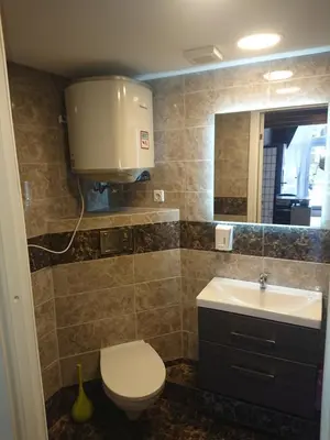 a bathroom with a toilet and a sink and a mirror at Loftas in Druskininkai