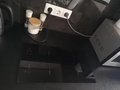 a desk with a laptop and a charger and a computer at Loftas in Druskininkai