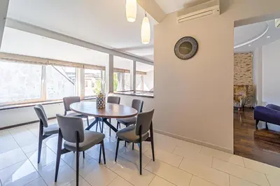 a dining room with a table and chairs at Grand Apt with air conditioning in Kaunas