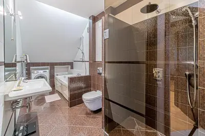 a bathroom with a toilet and a sink and a shower at Grand Apt with air conditioning in Kaunas