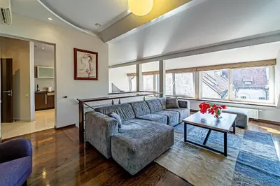 a living room with a couch and a table at Grand Apt with air conditioning in Kaunas