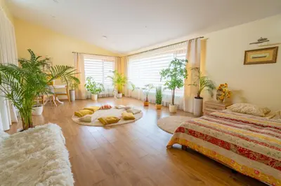 a bedroom with a bed and potted plants in it at Cozy house in Vilnius in Vilnius