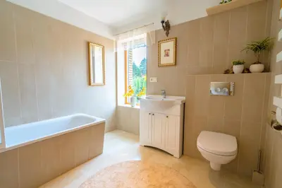 a bathroom with a tub and a toilet and a sink at Cozy house in Vilnius in Vilnius