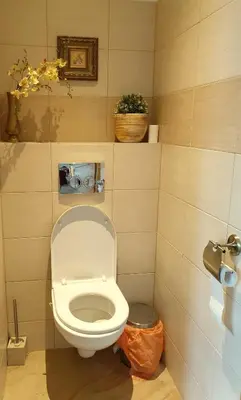 a bathroom with a white toilet in a room at Cozy house in Vilnius in Vilnius