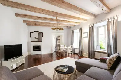 a living room with a couch and a tv at 3 Bedroom Duplex Apartment next to the Gates of Dawn in Vilnius
