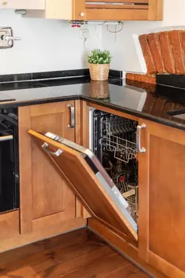 a dishwasher with its door open in a kitchen at 3 Bedroom Duplex Apartment next to the Gates of Dawn in Vilnius