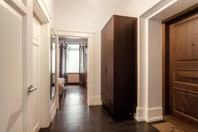 a hallway with a wooden door and a hallway with a hallway at 3 Bedroom Duplex Apartment next to the Gates of Dawn in Vilnius