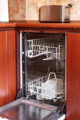 a dishwasher with two baskets in it in a kitchen at Classic Old Town Apartment next to the Gates of Dawn in Vilnius
