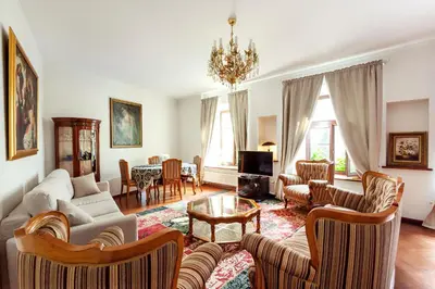 a living room with a couch and chairs at Classic Old Town Apartment next to the Gates of Dawn in Vilnius