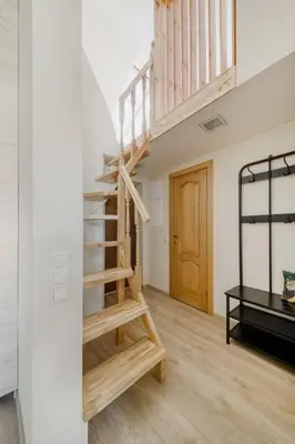 a room with a wooden staircase in a building at Old Town Apartment in Vilnius