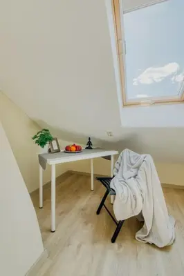 a room with a table and a chair with a blanket at Old Town Apartment in Vilnius