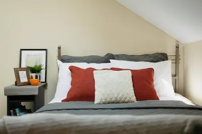a bedroom with a bed with red and white pillows at Old Town Apartment in Vilnius