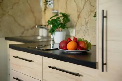 a plate of fruit on a counter in a kitchen at Old Town Apartment in Vilnius