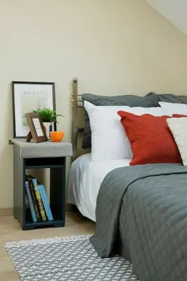 a bedroom with a bed and a nightstand next to a bed at Old Town Apartment in Vilnius