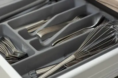 a drawer filled with forks and spoons andsilver utensils at Cathedral apartment, perfect for couples in Vilnius