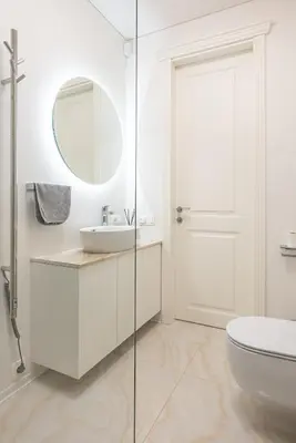 a white bathroom with a sink and a mirror at Cathedral apartment, perfect for couples in Vilnius