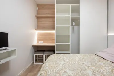 a bedroom with a bed and a desk with a television at Cathedral apartment, perfect for couples in Vilnius