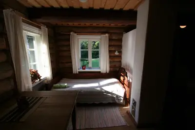 a small room with a bed and a window at Miškiniškės in Ignalina